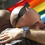 Gay rights activists embrace outside Spain’s parliament in Madrid