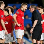 Manchester United’s Vidic talks referee Dowd after being sent off during their English Premier League soccer match against Chelsea at Stamford Bridge